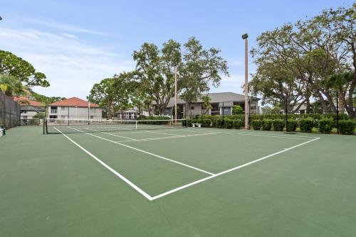 a tennis court in front of some houses at Siren’s Song, Minutes to IMG & Anna Maria Island in Bradenton