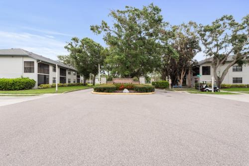 a driveway in front of a house with trees at Siren’s Song, Minutes to IMG & Anna Maria Island in Bradenton