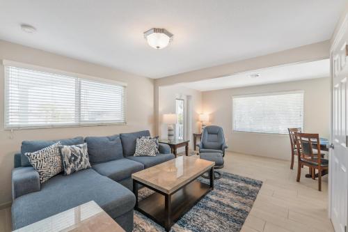 a living room with a blue couch and a table at A Beach Retreat on Casey Key in Venice