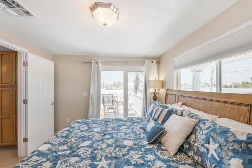 a bedroom with a bed with a blue comforter at A Beach Retreat on Casey Key in Venice