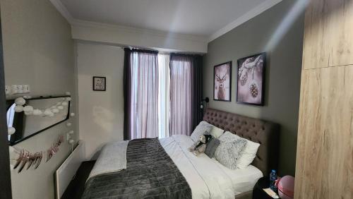 a bedroom with a bed with a teddy bear on it at Ski in Ski out Tiamo Apartment 302-303 at Gudauri loft hotel in Gudauri