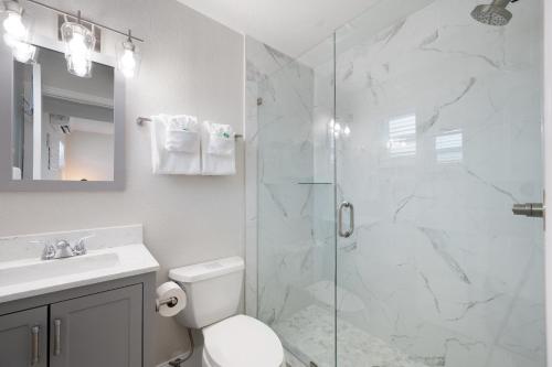 a bathroom with a shower and a toilet and a sink at A Beach Retreat on Casey Key in Venice