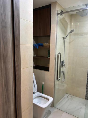 a bathroom with a shower with a toilet and a sink at Escape Condominium Mea Pim Beach Rayong in Mae Pim