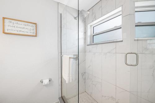 a bathroom with a shower with a glass door at A Beach Retreat on Casey Key in Venice