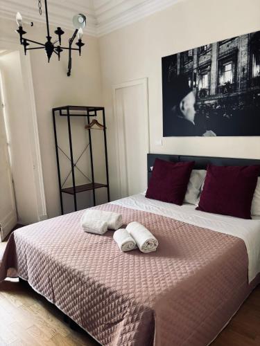 a bedroom with a bed with two towels on it at Stanze di Agatha in Catania