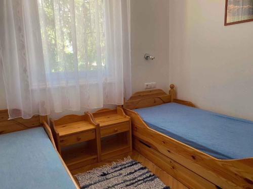 two twin beds in a room with a window at Holiday home in Balatonmariafürdo 19477 in Balatonmáriafürdő