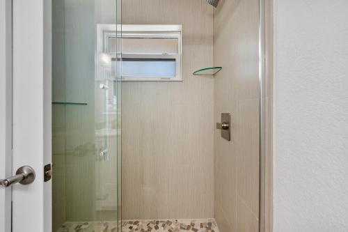 a shower with a glass door in a bathroom at A Beach Retreat on Casey Key in Venice