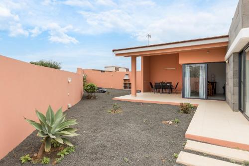 a backyard of a house with a patio at Home2Book Chill BBQ Hideaway in Corralejo in Corralejo