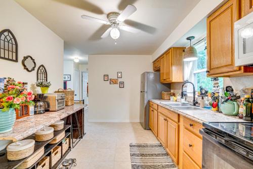 a kitchen with wooden cabinets and a ceiling fan at 10 Mi to Crystal River Home in Citrus County in Beverly Hills