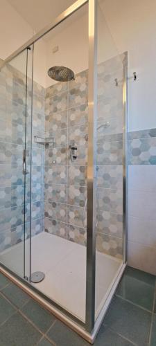 a shower with a glass door in a bathroom at Il Flauto Magico in Belmonte Calabro