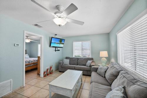 a living room with a couch and a ceiling fan at A Beach Retreat on Casey Key in Venice