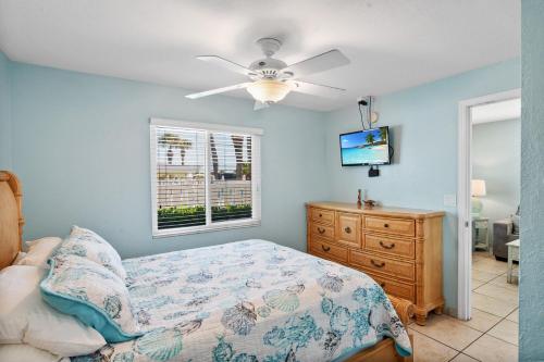 a bedroom with a bed and a ceiling fan at A Beach Retreat on Casey Key in Venice