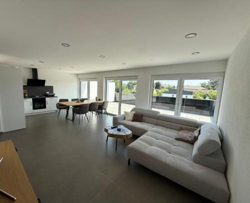 a living room with a couch and a table at Stilvolle Penthouse Wohnung in Horb am Neckar