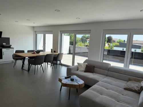 a living room with a couch and a table with chairs at Stilvolle Penthouse Wohnung in Horb am Neckar