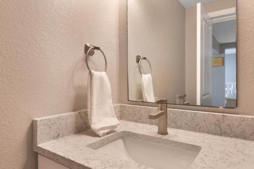 a bathroom with a sink and a mirror at A Beach Retreat on Casey Key in Venice