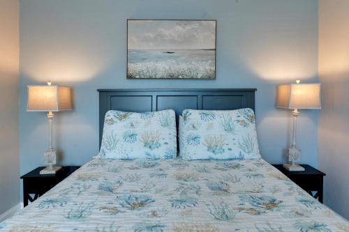 a bedroom with a bed with blue walls and two lamps at A Beach Retreat on Casey Key in Venice