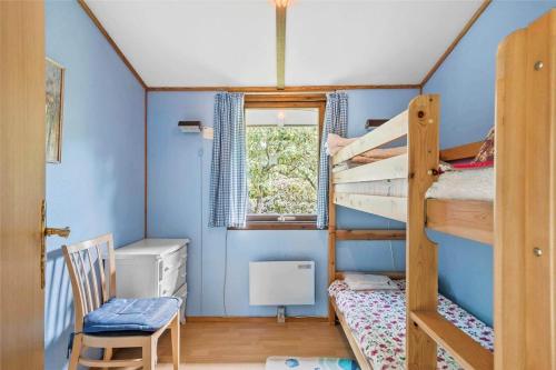 a room with two bunk beds and a chair at R845-Rodvig-Maelskifterne-51 in Rødvig