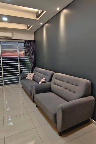a couch in a room with a wall at Majestic Sanctuary Homestay Taiping with Netflix - 2 Carpark in Taiping