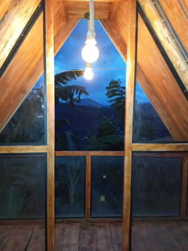 a view from the inside of a room with a large window at Ella Shia Cabana in Badulla