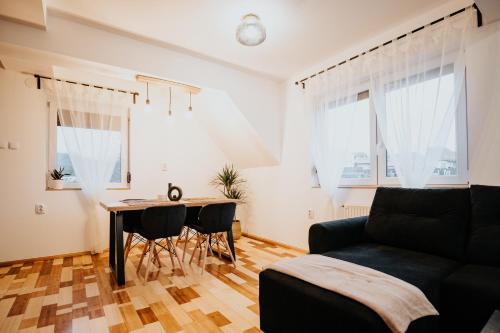 a living room with a couch and a table at DOUX Apartman House in Odorheiu Secuiesc