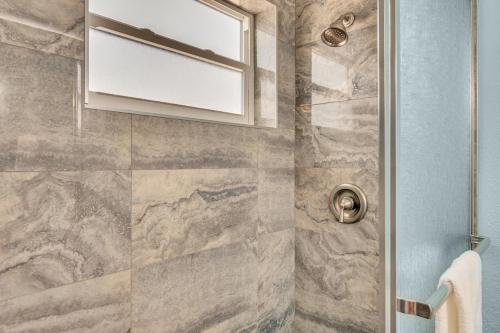 a bathroom with a shower with a window at A Beach Retreat on Casey Key in Venice