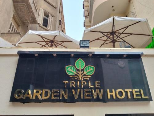 a sign for a caribbean view hotel on a building at Triple Garden Studios and apartments in Cairo