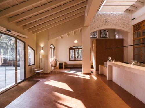 a large room with a kitchen and a large window at wecamp Cala Montgó in L'Escala
