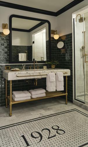 a bathroom with a sink and a mirror at Hotel 1928 in Waco