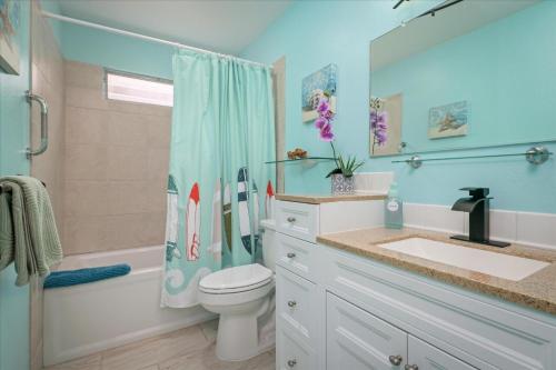 a bathroom with a toilet and a sink and a shower at Keauhou Palena 901 in Kailua-Kona