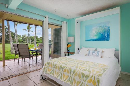 a bedroom with blue walls and a bed and a patio at Keauhou Palena 901 in Kailua-Kona