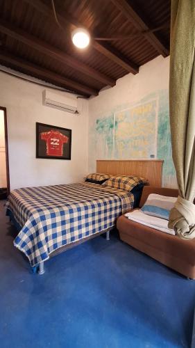 two beds sitting in a room with blue carpet at The Blue House Panama in Chame