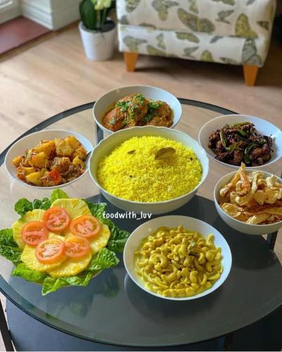 a glass table with different bowls of food on it at Blue Moon Villa in Waskaduwa