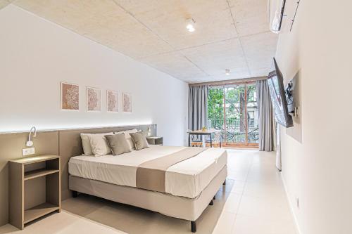 a bedroom with a bed and a large window at Deluxe Recoleta Apartments - By Magno in Buenos Aires