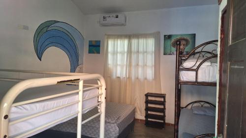 a bedroom with two bunk beds and a ladder at The Blue House Panama in Chame