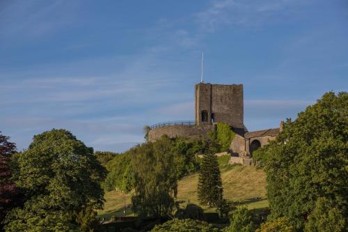 an old castle on top of a hill with trees at Parson Castle View, Sleeps 6, Clitheroe Centre in Clitheroe