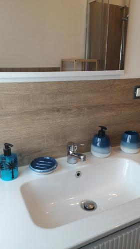 a bathroom sink with blue dishes on top of it at Il Rifugio di Mario in Monzuno