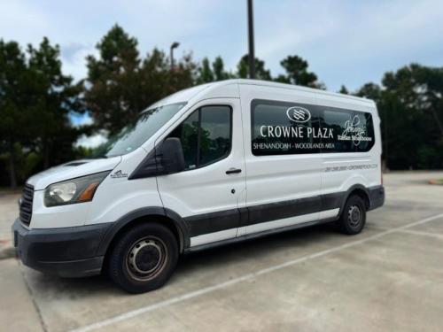 a white van parked in a parking lot at Crowne Plaza Shenandoah - The Woodlands Area by IHG in The Woodlands