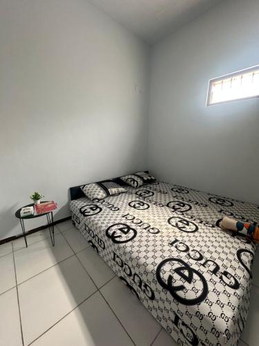 a bedroom with a bed and a table in it at risky syariah in Kepanjen