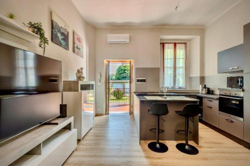 a kitchen with a counter and stools in it at Moon Light in Rozzano