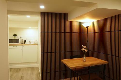 a room with a table with a vase of flowers on a wall at ION House - near shopping and Kennedy subway in Toronto