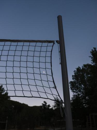 a volleyball net in front of a pole at wecamp Santa Cristina in Santa Cristina d'Aro