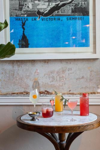 a table with drinks and candles on it at Artist Residence Bristol in Bristol