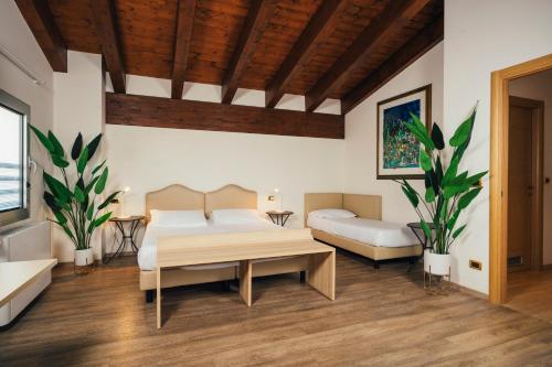 a living room with two beds and a table at Euro Hotel in Imola