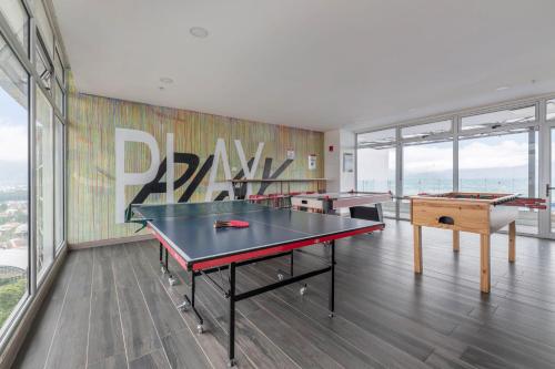 a room with two ping pong tables and a mural at Urban Breeze iFreses, 10th floor! AC, TV and Pool in Guayabos