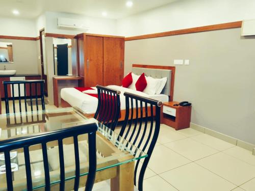 a living room with a bed and a glass table at The Rosetta Castle in Kalpetta