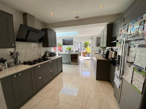 a kitchen with gray cabinets and a large kitchen at Modern Room in Cardiff, Wales in Cardiff