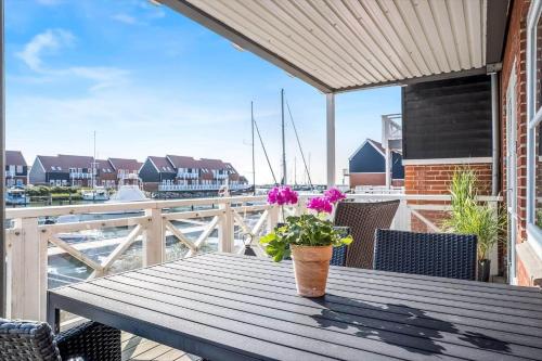 a wooden table with a potted plant on a balcony at 4128-Borre-Klintholm-Havneby-28 in Borre