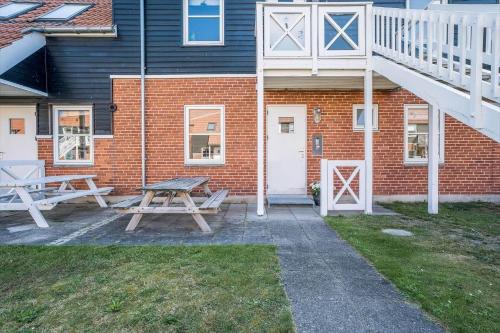a picnic table in front of a brick building at 4128-Borre-Klintholm-Havneby-28 in Borre