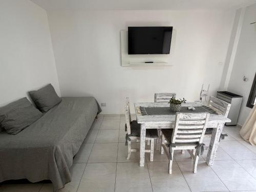 a room with a table and a bed and a television at Alquiler Temporario in Santa Rosa