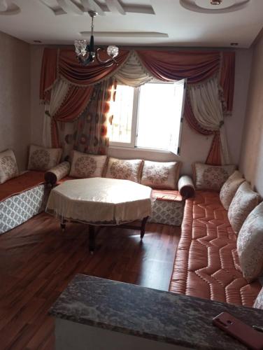 a living room with a couch and a window at Apparemment hay Adrar agadir à côté de carrefour in Agadir